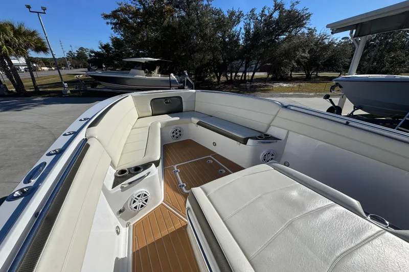 Slide: The Image of 2016 Nor-Tech 390 Sport Center Console boat interior with cushioned seating and speakers. - 20