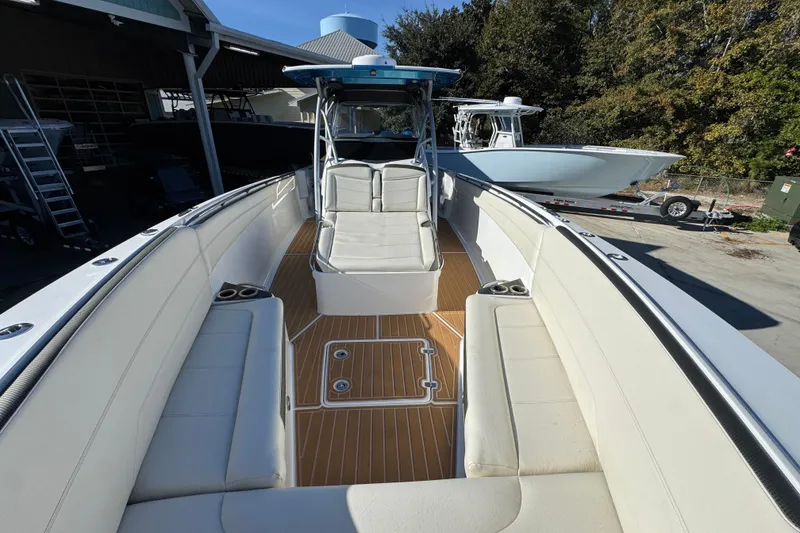Slide: The Image of 2016 Nor-Tech 390 Sport Center Console boat with spacious seating and sleek design. - 23
