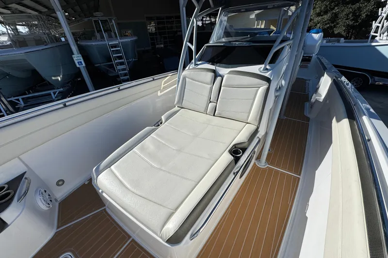 Slide: The Image of 2016 Nor-Tech 390 Sport Center Console with cushioned seating and sleek design. - 24