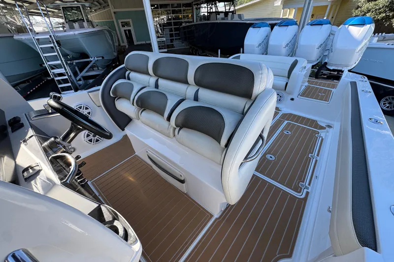 Slide: The Image of 2016 Nor-Tech 390 Sport Center Console with luxurious seating and multiple outboard engines. - 28