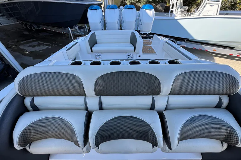 Slide: The Image of 2016 Nor-Tech 390 Sport Center Console with cushioned seating and multiple outboard engines. - 29