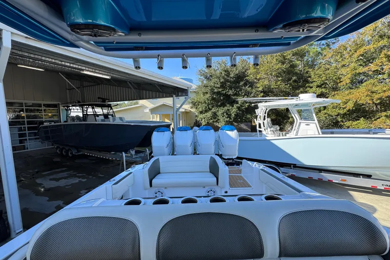 Slide: The Image of 2016 Nor-Tech 390 Sport Center Console boat with multiple engines in a marina. - 30