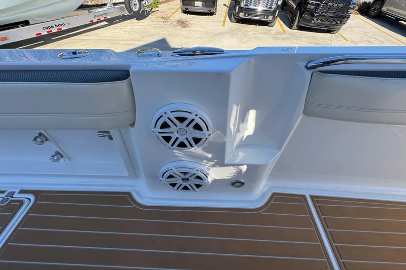 Slide: The Image of 2016 Nor-Tech 390 Sport Center Console boat interior with speakers and cushioned seating. - 31