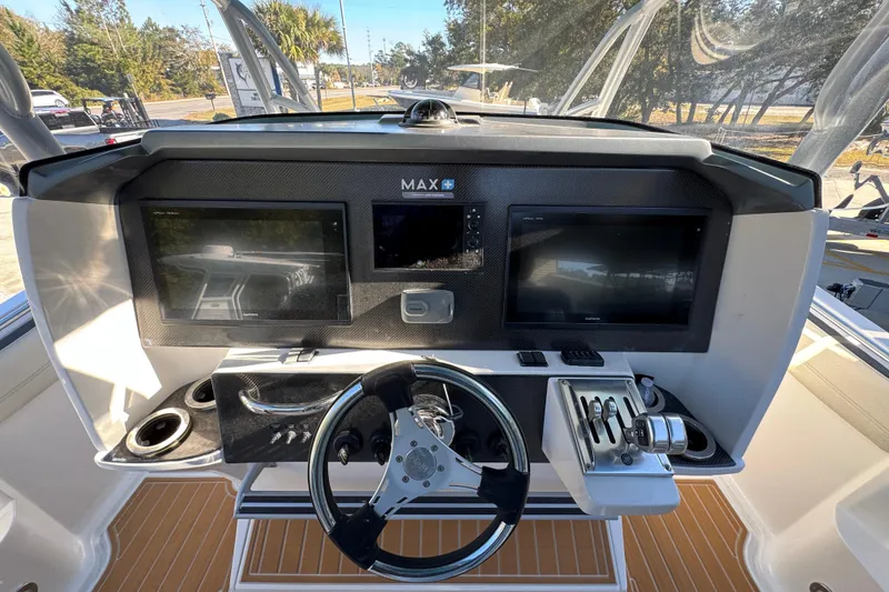 Slide: The Image of 2016 Nor-Tech 390 Sport Center Console helm with dual Garmin displays and steering wheel. - 34