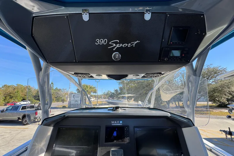 Slide: The Image of 2016 Nor-Tech 390 Sport Center Console dashboard with electronics and overhead storage. - 35