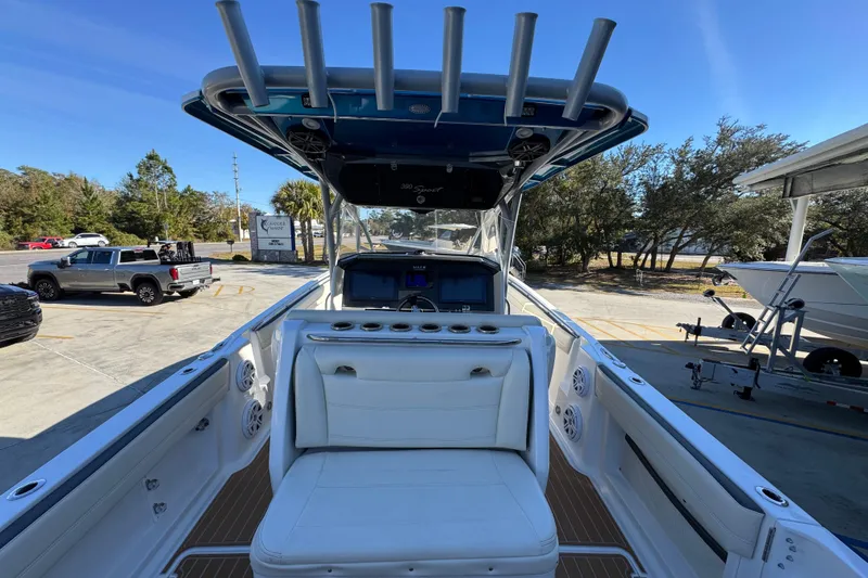 Slide: The Image of 2016 Nor-Tech 390 Sport Center Console boat with white seating and rod holders. - 39