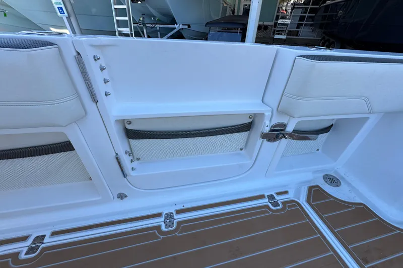 Slide: The Image of 2016 Nor-Tech 390 Sport Center Console interior with storage compartments and cushioned seating. - 42