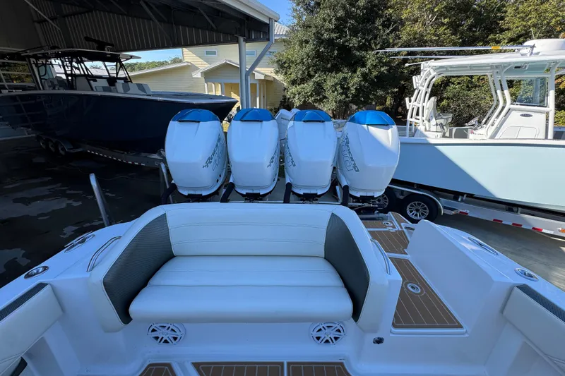 Slide: The Image of 2016 Nor-Tech 390 Sport Center Console with four powerful outboard engines, docked under a shelter. - 43