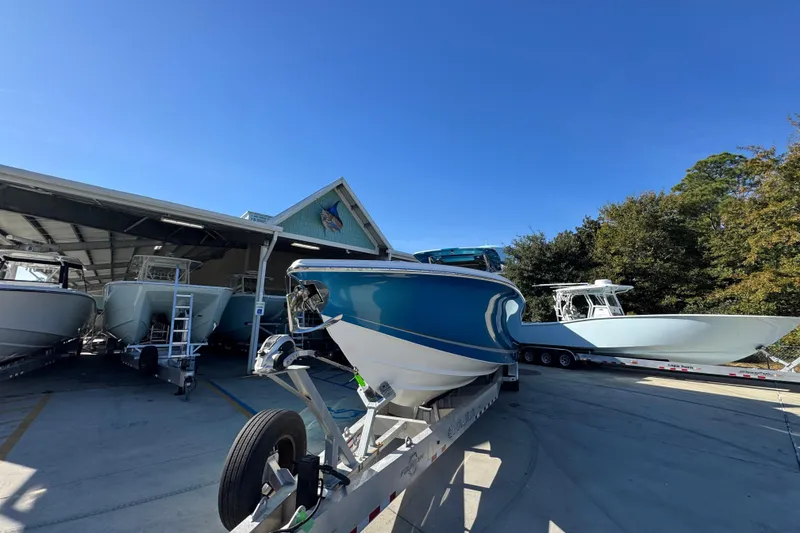 Slide: The Image of 2016 Nor-Tech 390 Sport Center Console boats on trailers at a marina under clear blue skies. - 6