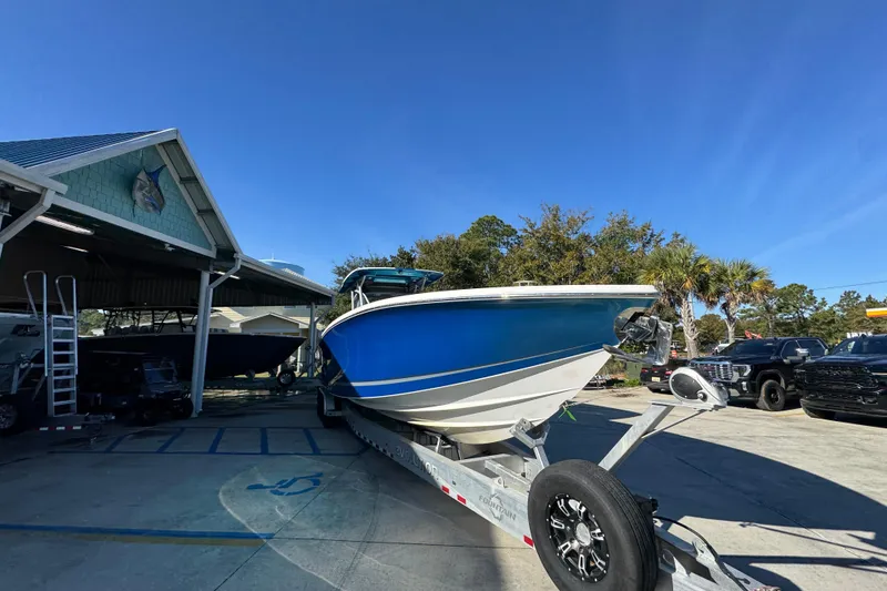 Slide: The Image of 2016 Nor-Tech 390 Sport Center Console boat on trailer, parked outdoors. - 8