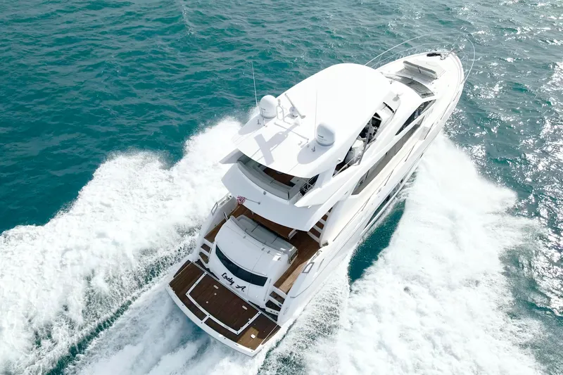 Slide: The Image of 2017 Sunseeker Manhattan 65 yacht cruising on open water, aerial view. - 1