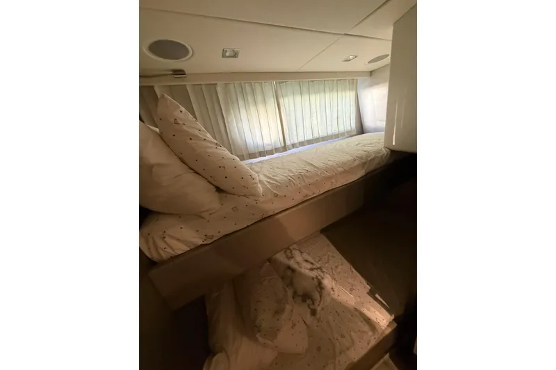 Slide: The Image of Interior of 2017 Sunseeker Manhattan 65 yacht with cozy bunk beds and soft lighting. - 19
