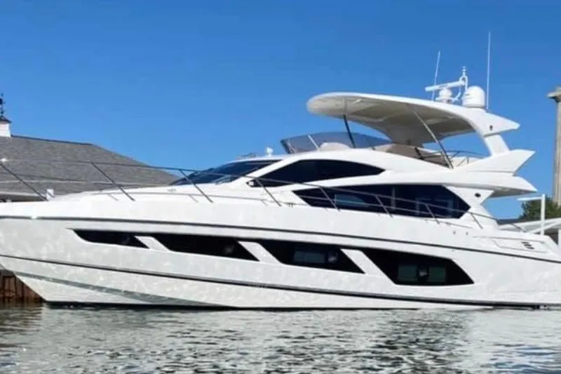 Slide: The Image of 2017 Sunseeker Manhattan 65 yacht on water, sleek design, clear blue sky. - 7