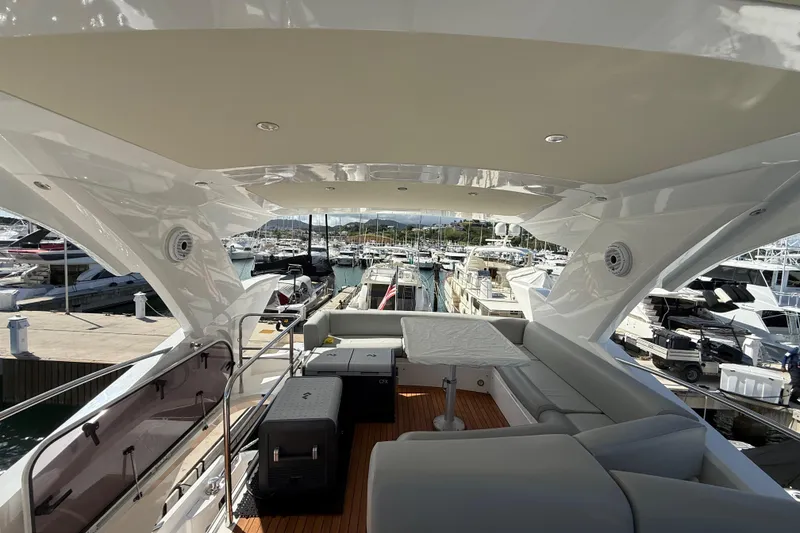 Slide: The Image of Luxurious 2017 Sunseeker Manhattan 65 yacht interior at marina, showcasing elegant seating and design. - 9