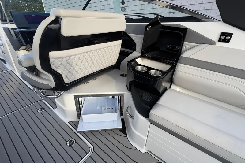 Slide: The Image of Interior of 2026 Sea Ray SLX 280 Outboard with fridge and cup holders. - 24
