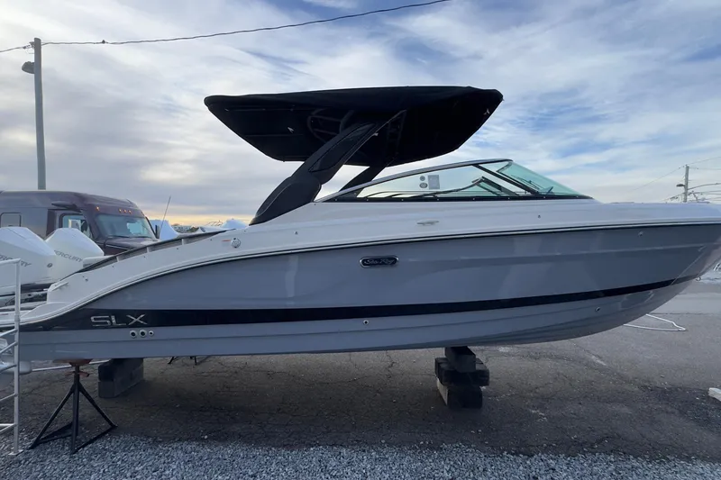 Slide: The Image of 2026 Sea Ray SLX 280 Outboard boat on a parking lot. - 3