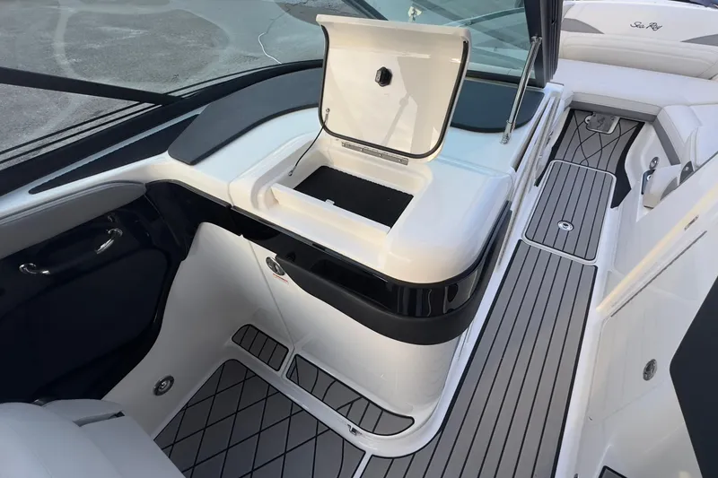 Slide: The Image of Interior of 2026 Sea Ray SLX 280 Outboard with open storage compartment. - 32