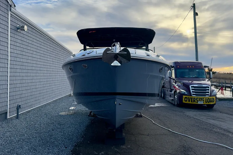 Slide: The Image of 2026 Sea Ray SLX 280 Outboard in front of an oversized load truck. - 4