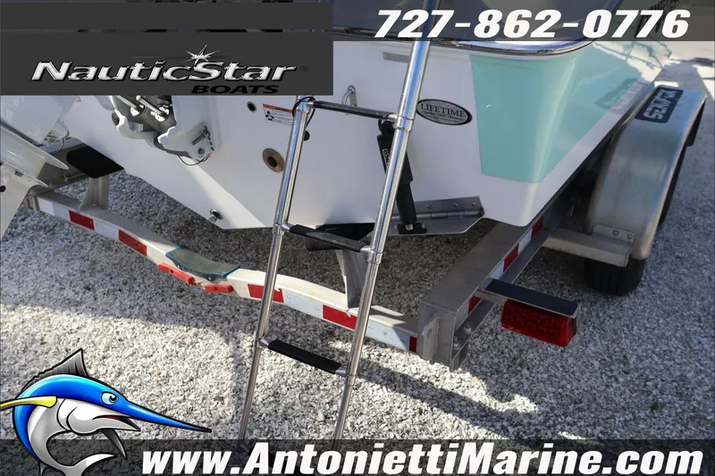 Slide: The Image of 2026 NauticStar 222 Offshore boat on trailer with ladder, displayed by Antonietti Marine. - 12