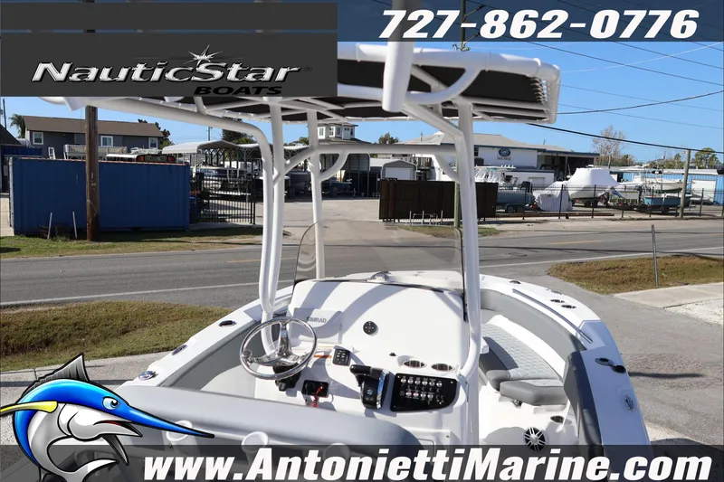 Slide: The Image of 2026 NauticStar 222 Offshore boat at Antonietti Marine dealership, showcasing helm and seating area. - 15