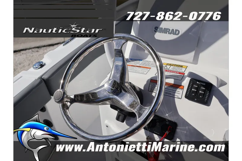 Slide: The Image of Steering wheel of 2026 NauticStar 222 Offshore boat with Simrad display and controls. - 29