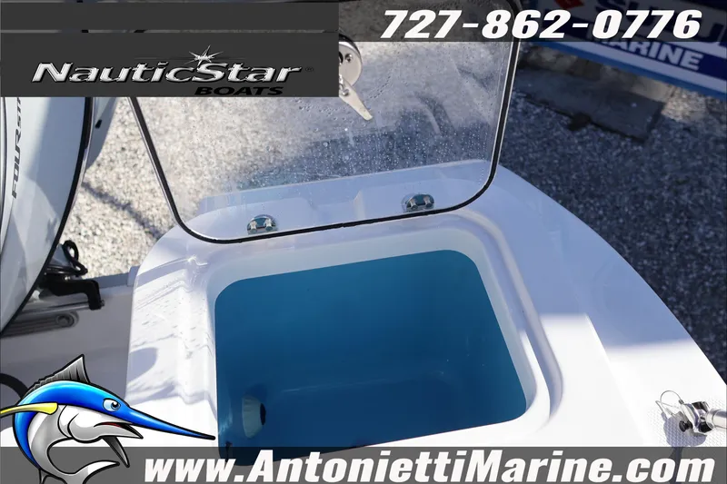 Slide: The Image of 2026 NauticStar 222 Offshore boat livewell with open lid, displayed at Antonietti Marine. - 19
