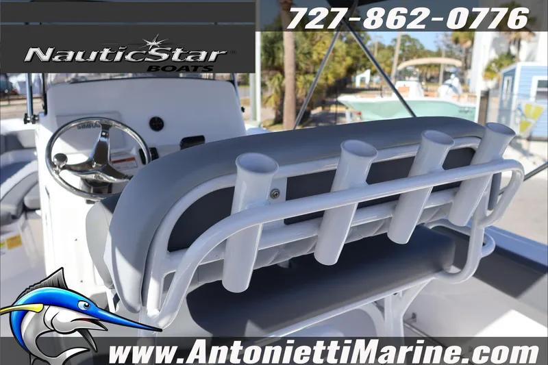 Slide: The Image of 2026 NauticStar 222 Offshore boat interior with rod holders and steering wheel. - 20