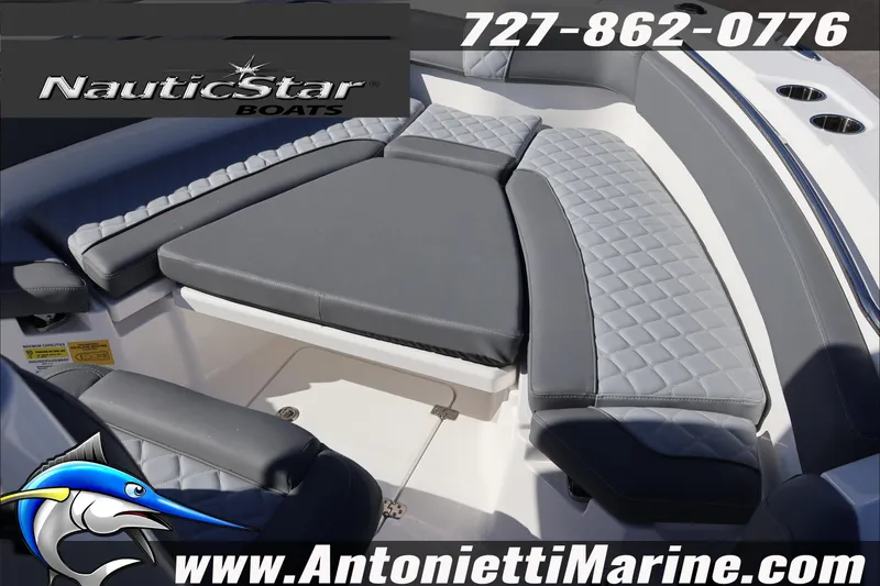 Slide: The Image of 2026 NauticStar 222 Offshore boat interior with cushioned seating, contact details, and logo. - 34