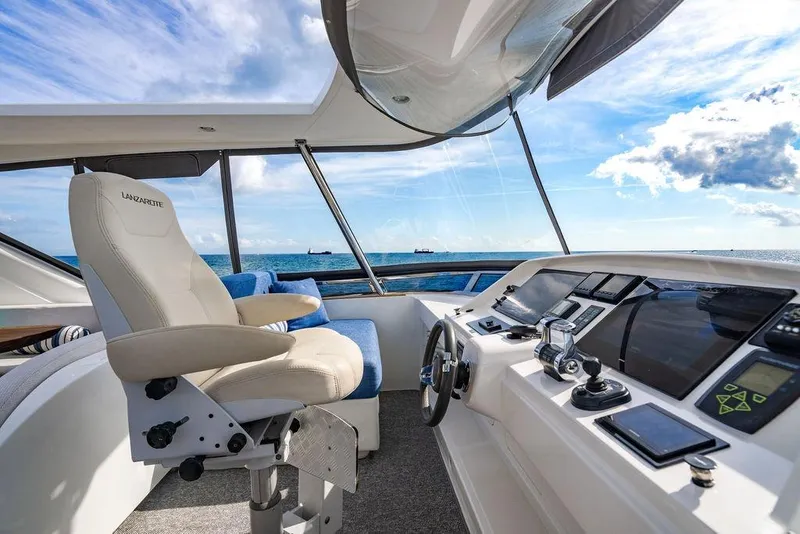 Slide: The Image of Luxurious Lanzarote Ventuno 73 yacht interior with wooden table, ocean view, and modern seating. - 36