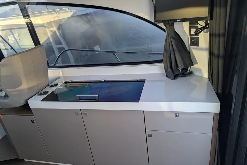Slide: The Image of 2024 Beneteau Antares 11 interior with modern kitchenette and sleek cabinetry. - 10