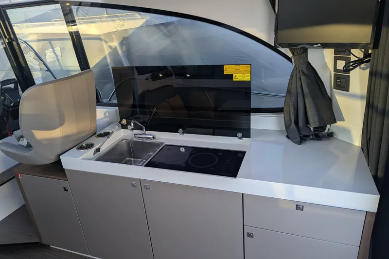 Slide: The Image of 2024 Beneteau Antares 11 kitchen with Kenyon electric cooktop. - 12