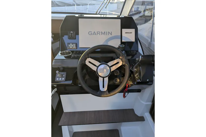 Slide: The Image of 2024 Beneteau Antares 11 joystick control on sleek black dashboard. - 15