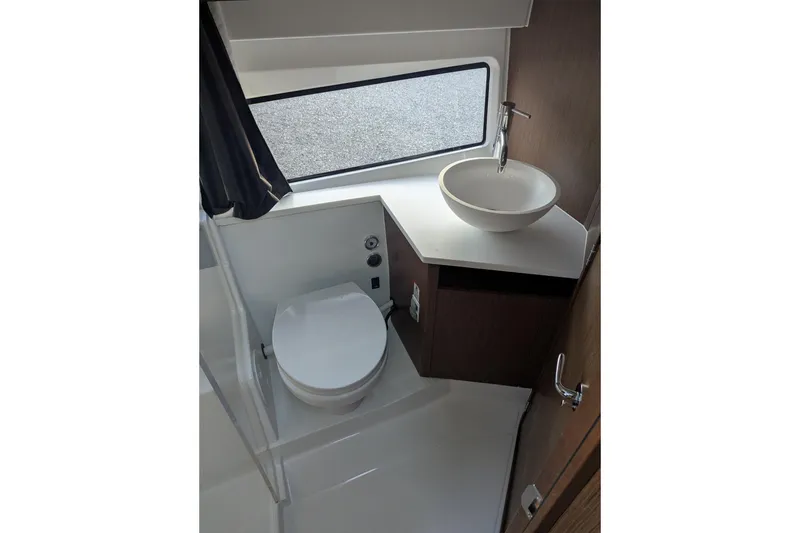 Slide: The Image of 2024 Beneteau Antares 11 bathroom with shower, window, and modern fixtures. - 18