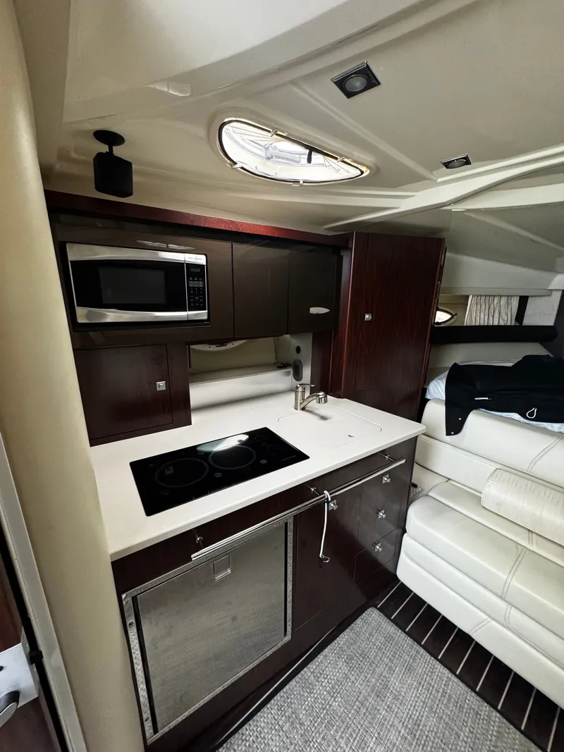 Slide: The Image of Interior of 2016 Monterey 335 Sport Yacht with kitchen and seating area. - 22