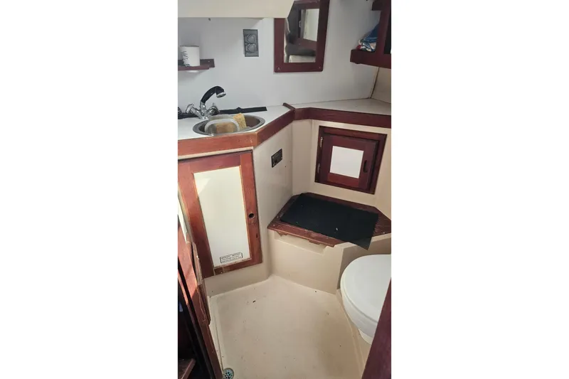Slide: The Image of 1988 Catalina 34 yacht bathroom with sink, mirror, and toilet. - 12