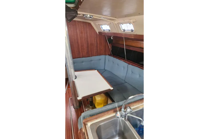 Slide: The Image of Interior of 1988 Catalina 34 sailboat with cozy seating and table. - 15