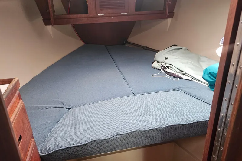 Slide: The Image of Interior cabin of 1988 Catalina 34 sailboat with blue cushions and storage space. - 18