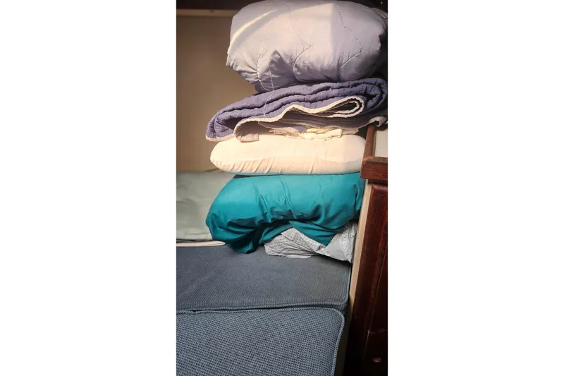 Slide: The Image of Stacked bedding in a 1988 Catalina 34 sailboat cabin. - 20
