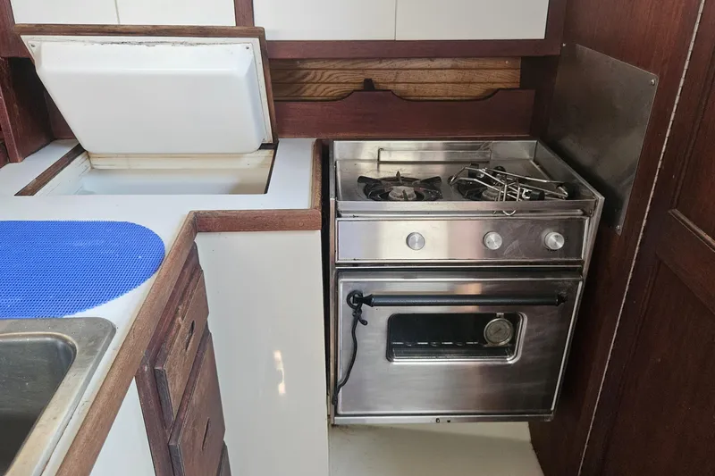 Slide: The Image of Galley kitchen in 1988 Catalina 34 sailboat with stove and storage. - 23