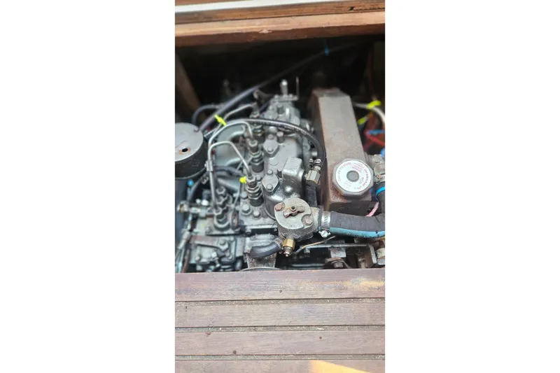 Slide: The Image of Engine compartment of a 1988 Catalina 34 sailboat, showcasing mechanical components. - 27