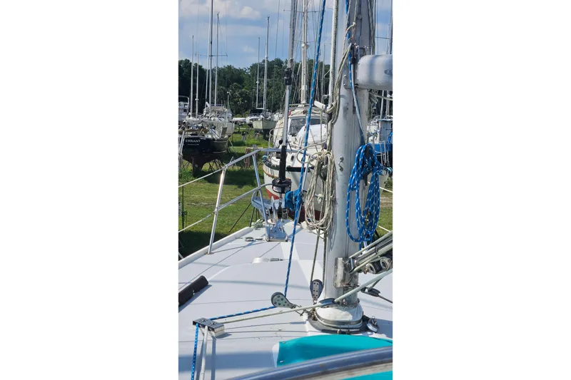 Slide: The Image of 1988 Catalina 34 sailboat deck view with rigging and marina background. - 3
