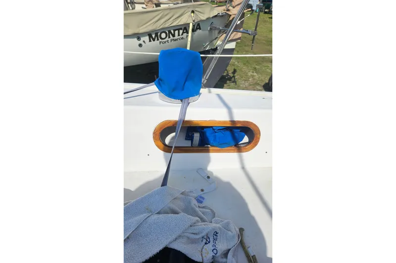 Slide: The Image of 1988 Catalina 34 sailboat cockpit with blue cover and wooden trim. - 7