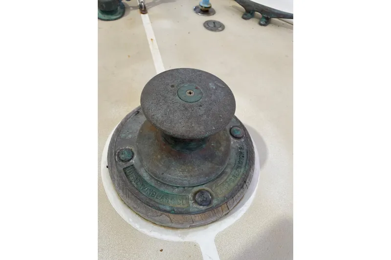 Slide: The Image of 1978 Grand Banks GB36570 boat winch on deck, showing weathered metal and nautical equipment. - 10