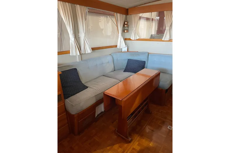 Slide: The Image of 1978 Grand Banks GB36570 yacht interior with cozy seating and wooden table. - 12