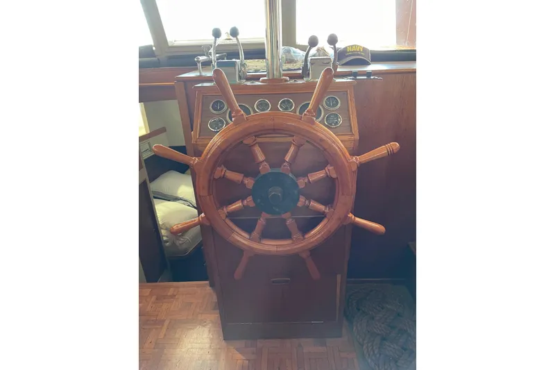 Slide: The Image of Wooden helm of 1978 Grand Banks GB36570 boat with gauges and controls. - 14