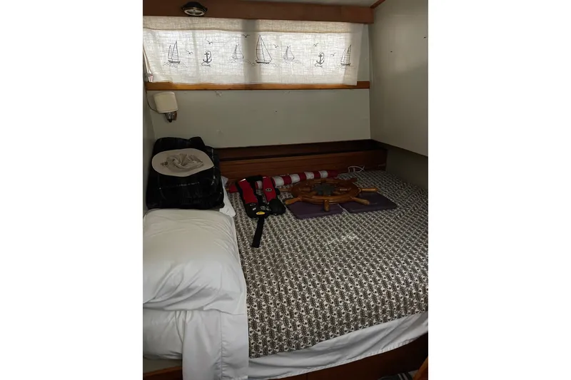 Slide: The Image of Cozy cabin interior of 1978 Grand Banks GB36570 with nautical decor and bedding. - 19