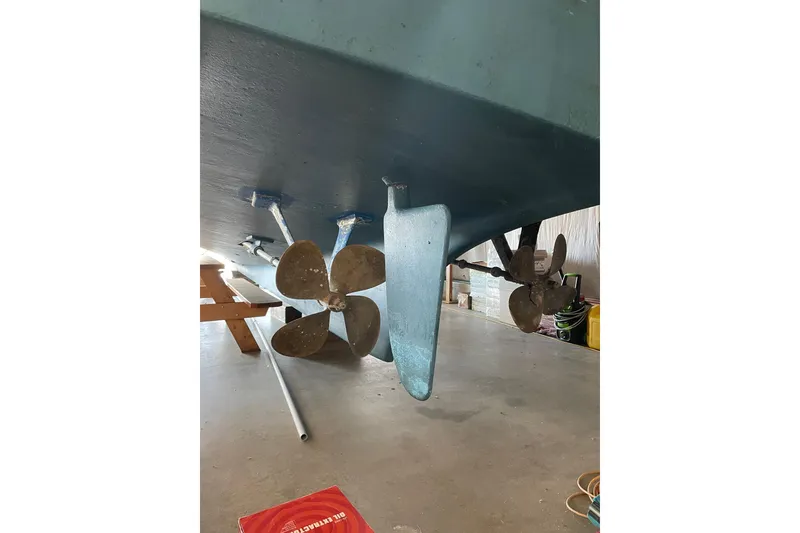 Slide: The Image of 1978 Grand Banks GB36570 boat propellers and rudder in a workshop setting. - 24