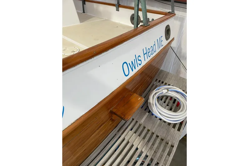 Slide: The Image of 1978 Grand Banks GB36570 boat with "Owls Head ME" text, wooden deck, and coiled rope. - 5