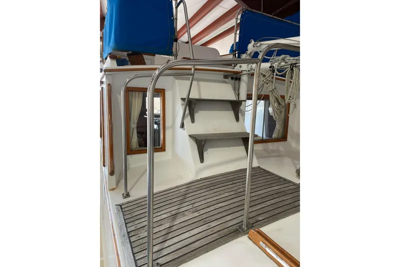 Slide: The Image of 1978 Grand Banks GB36570 boat deck with wooden flooring and metal railings. - 7