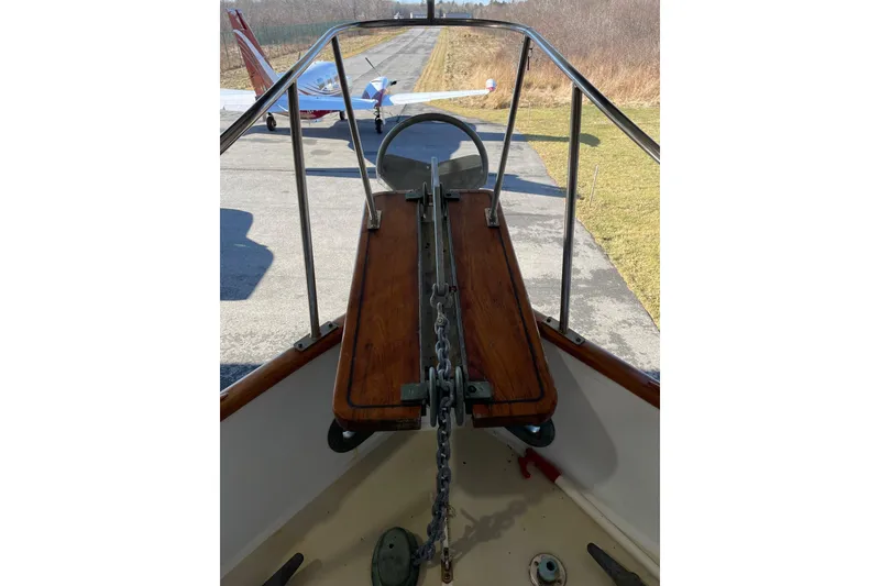 Slide: The Image of Bow view of 1978 Grand Banks GB36570 with anchor chain, docked near small aircraft. - 8